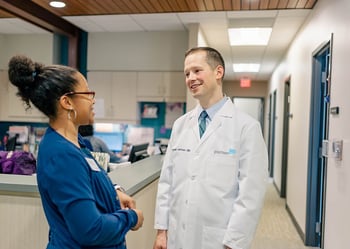 Dr. Jackson talks with his nurse at PartnerMD