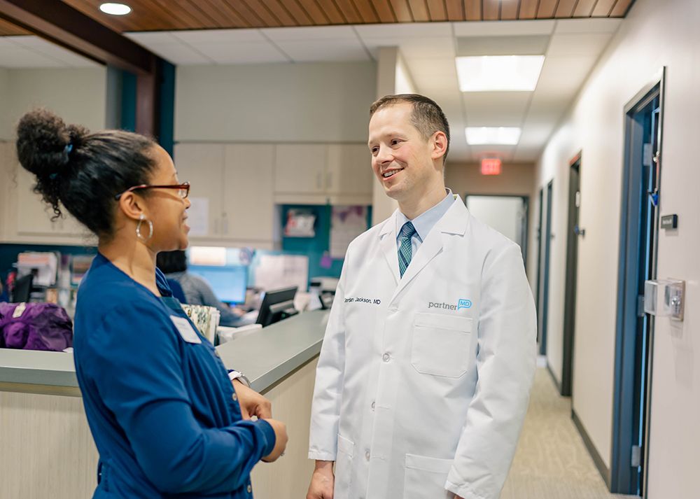 Dr. Jordan Jackson, a concierge doctor in Midlothian, VA, chats with his nurse