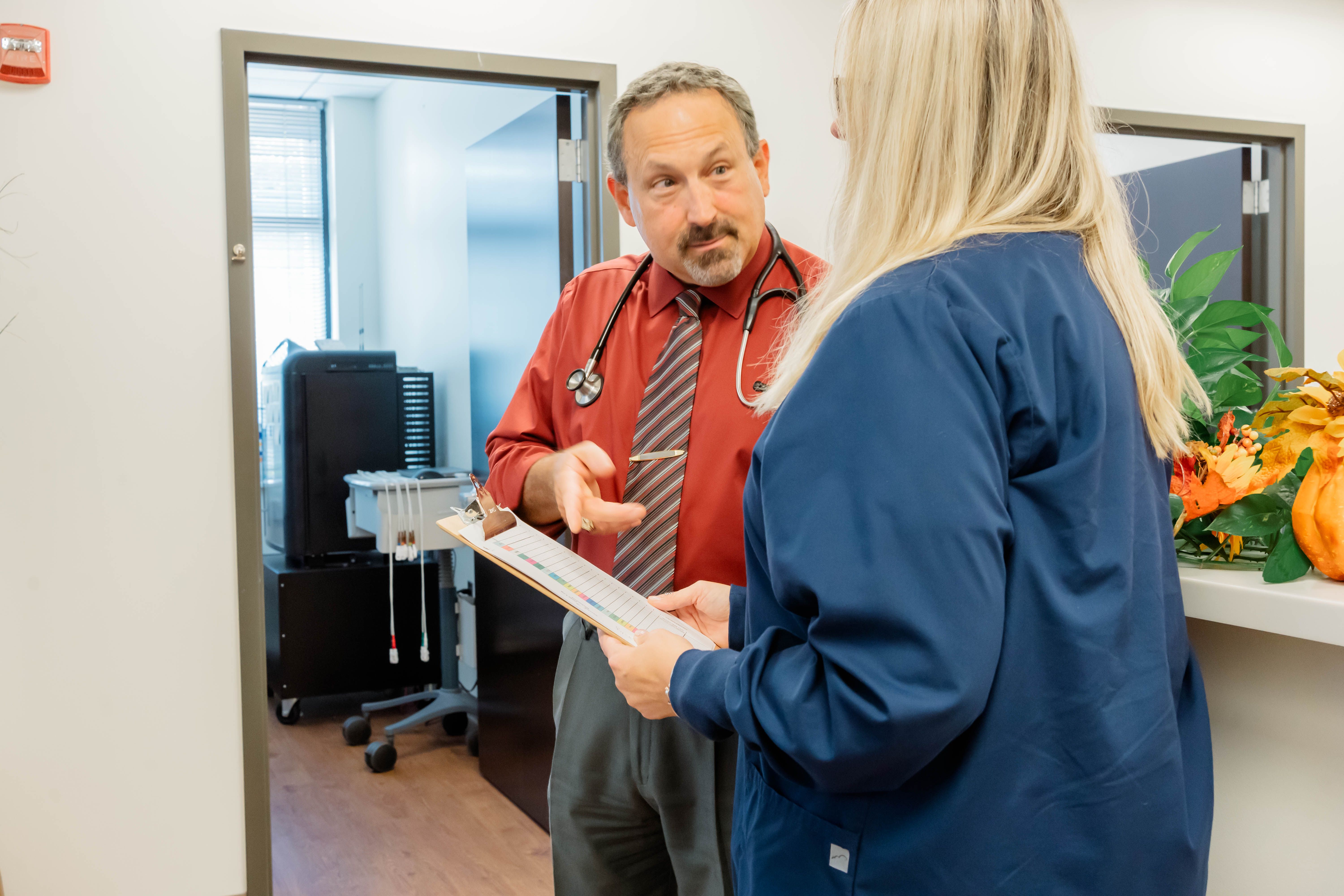 Dr. Carr, a concierge physician, speaks with a nurse