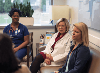 Dr. Rowe sitting on a couch at PartnerMD talking with a patient