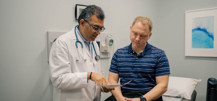 Dr. Sarma talking to patient during physical