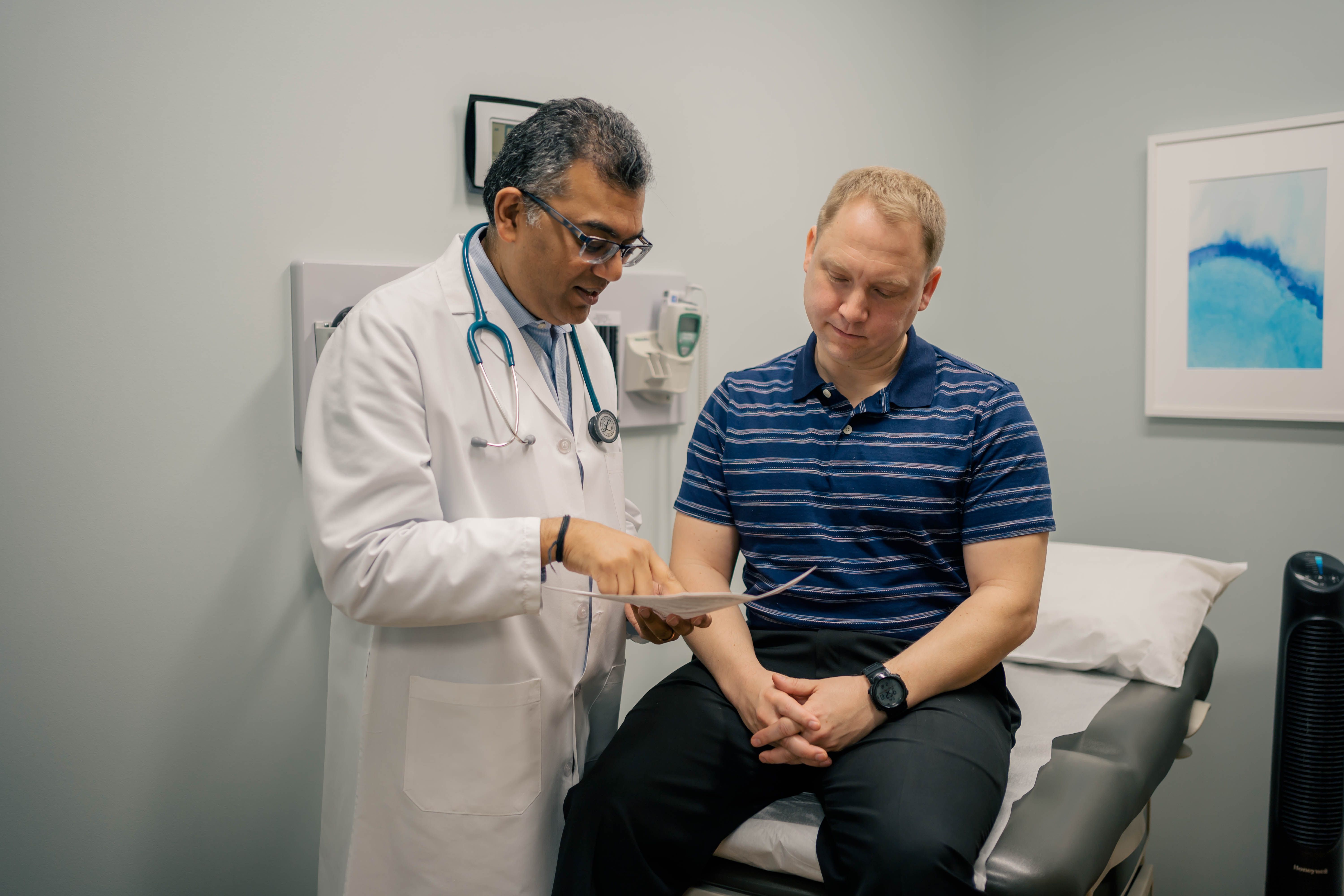 Sandy Springs concierge doctor Rakesh Sarma explains a test result to his patient