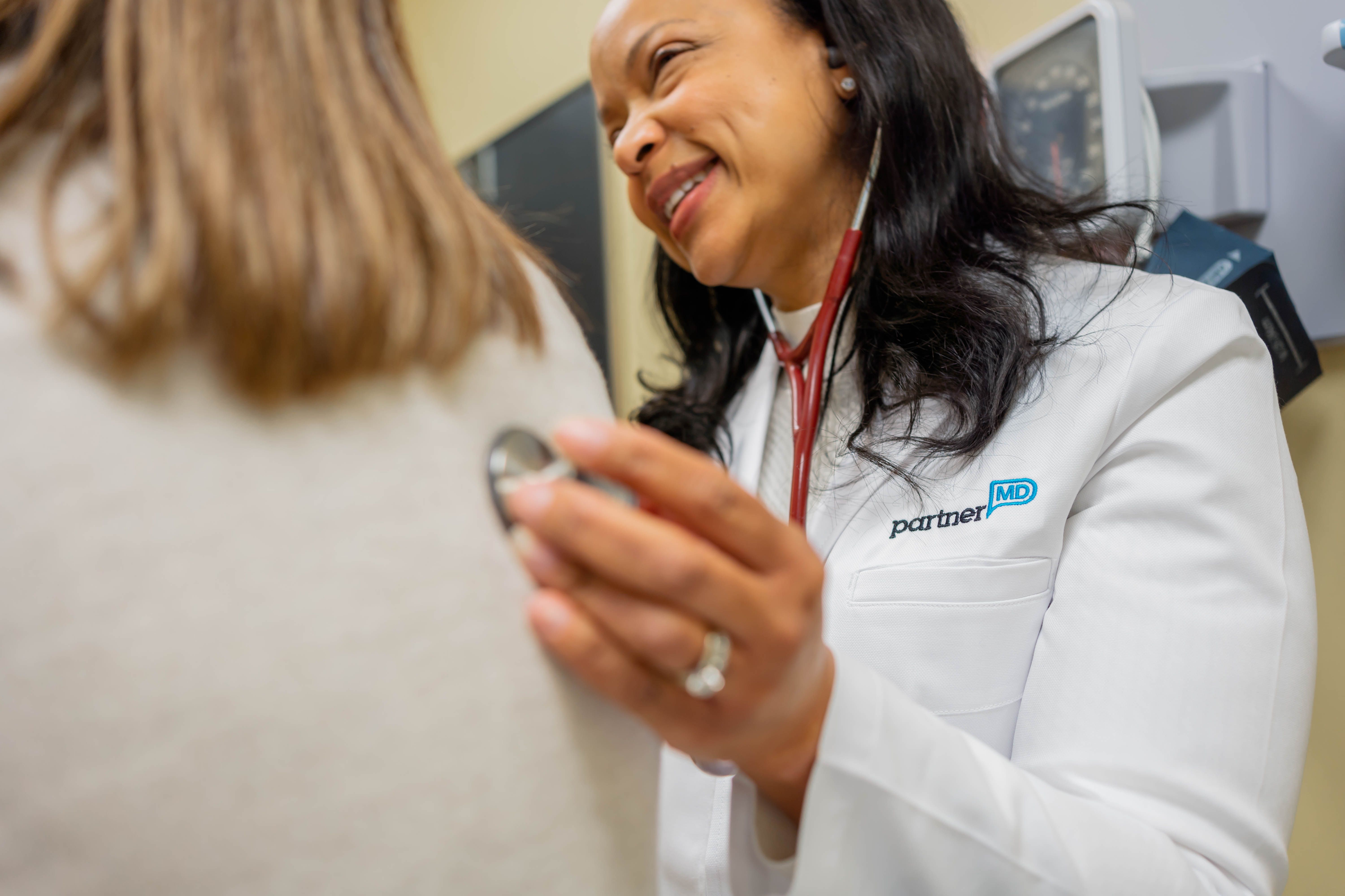 Dr. Jennifer Tutt, Concierge Doctor in Sandy Springs, listens to a patient
