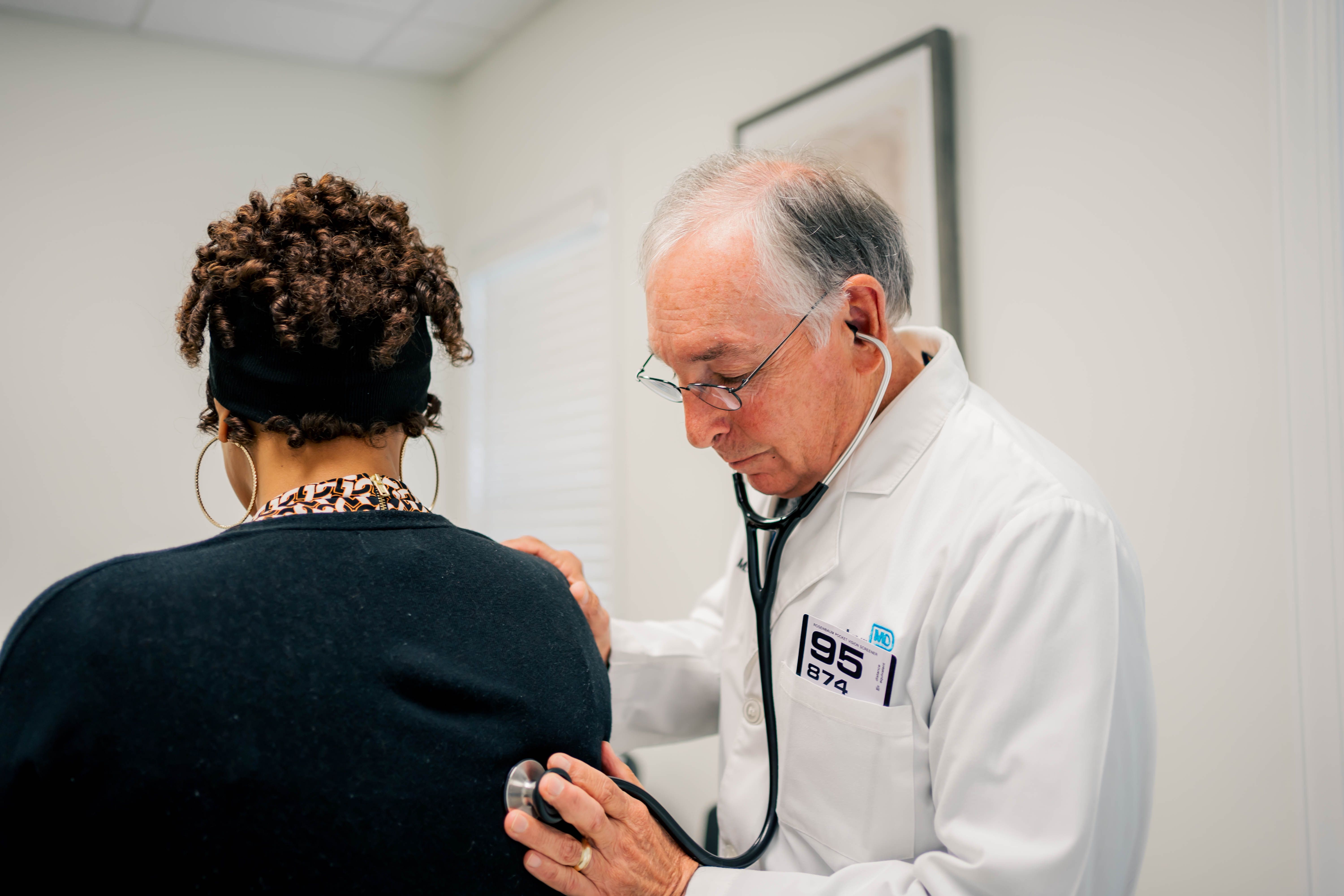 Dr. Jack Durham, PartnerMD Greenville concierge doctor, listens to a patient