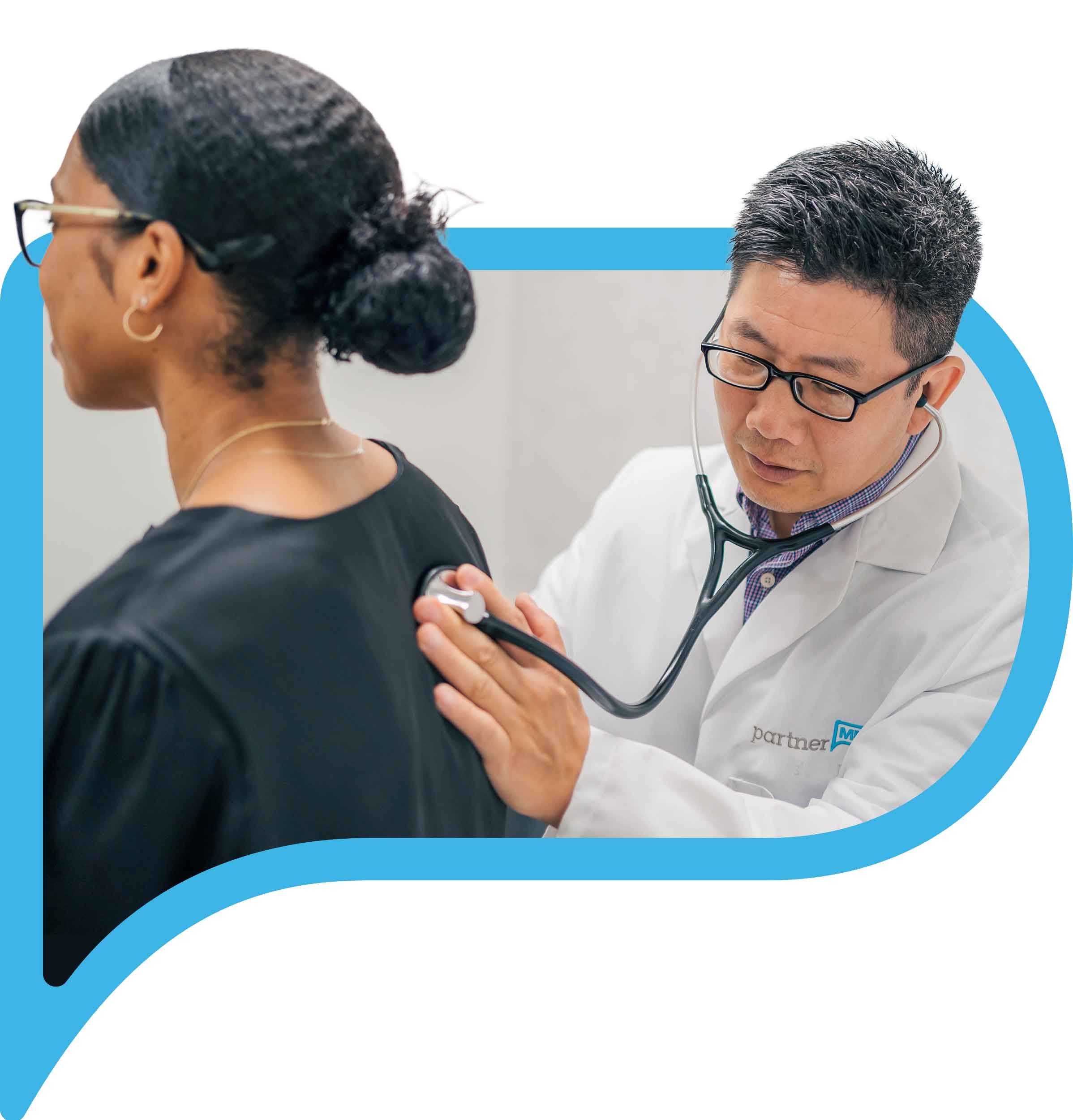 Dr. Shih listens to patient with stethoscope
