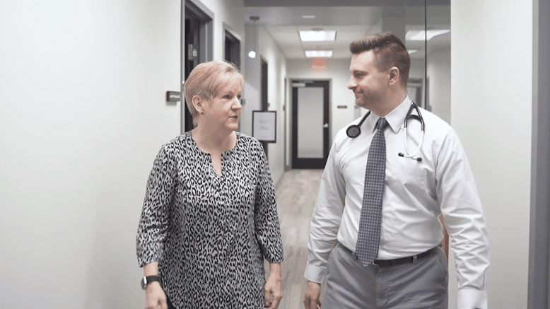 PartnerMD male physician talking with female patient