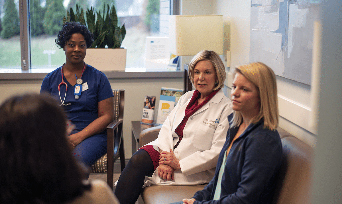 PartnerMD physician, health coach, and nurse meeting with a patient. 