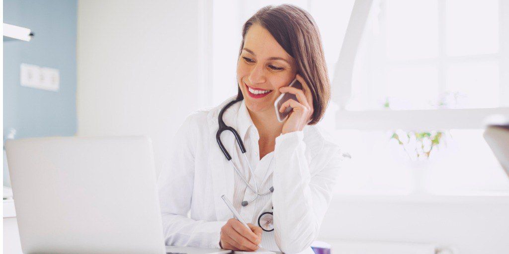 Female physician talking on phone with a patient