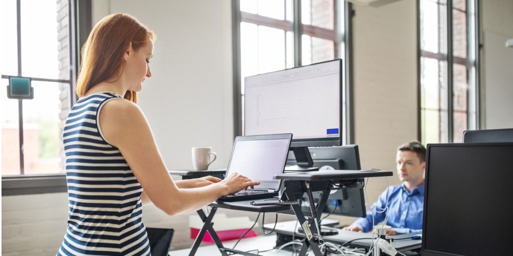 businesswoman-working-at-ergonomic-standing-desk-picture-id1150572075