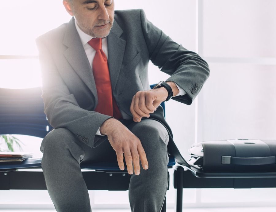 corporate-businessman-waiting-and-checking-the-time-picture-id837296500