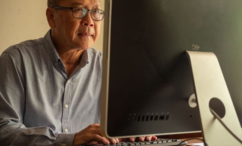 A man doing research on his computer