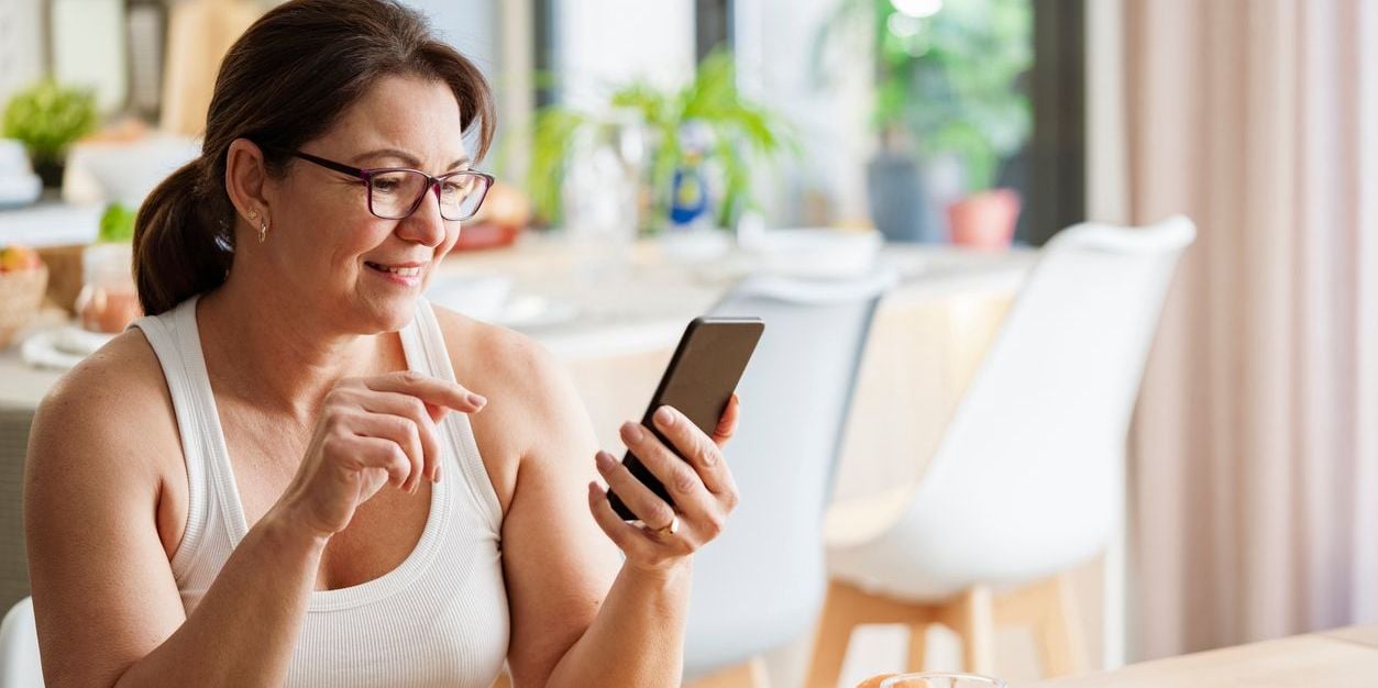 Woman using wellness tool to track food intake