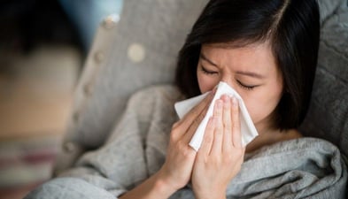 woman-sneezing-tissue-to-nose