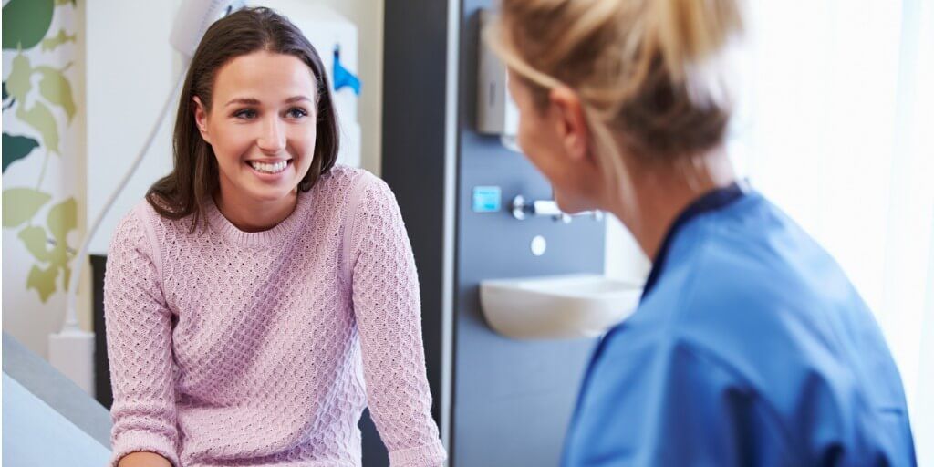 Female patient happily chatting with doctor