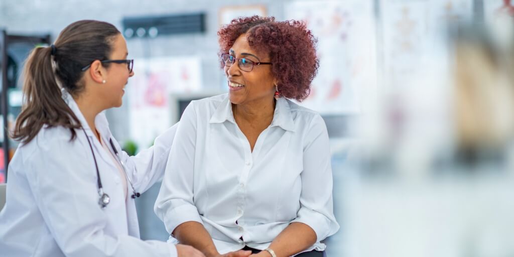 Female doctor talking to patient after concierge medicine physical