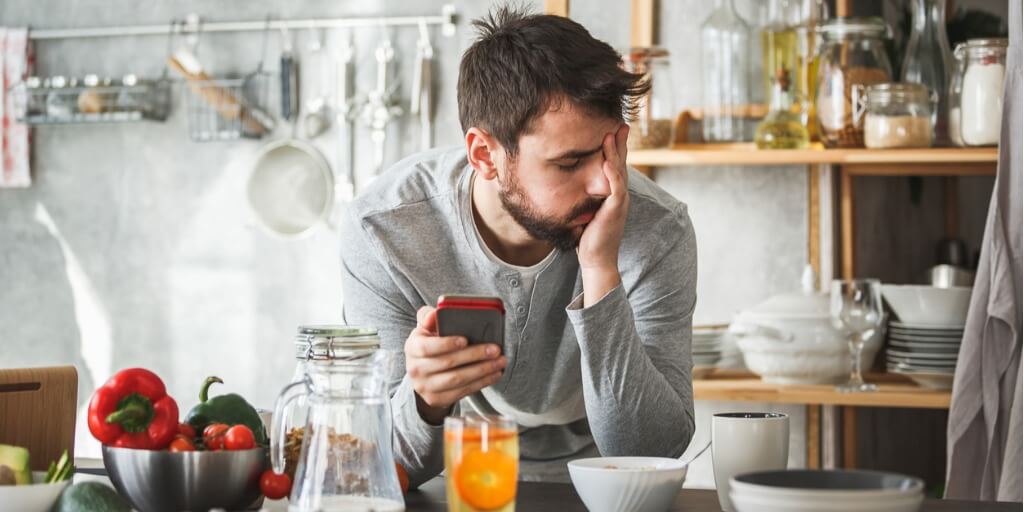 Sad middle-aged man thinking about crash dieting during breakfast