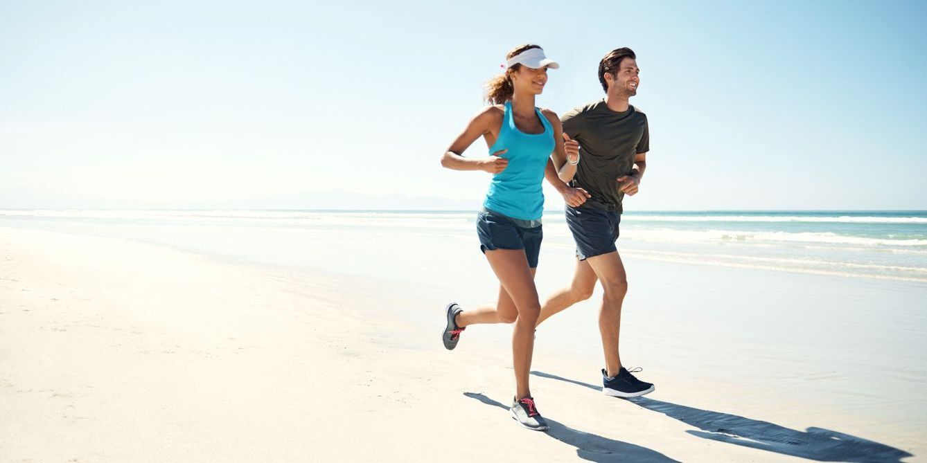 Couple running on beach.