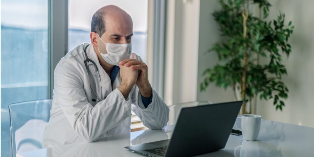 doctor helping a company manage key person risk through video conference