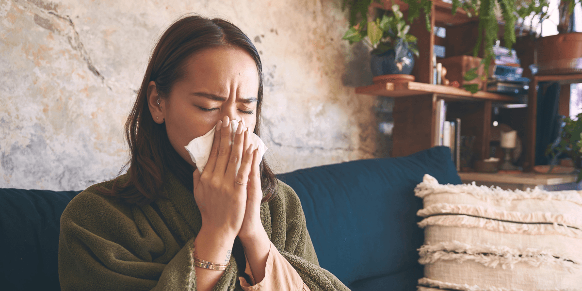 Woman blowing her nose