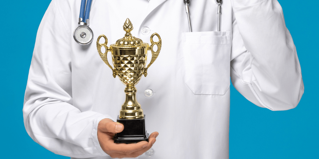 Physician holding trophy