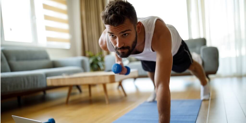Young man working out at home