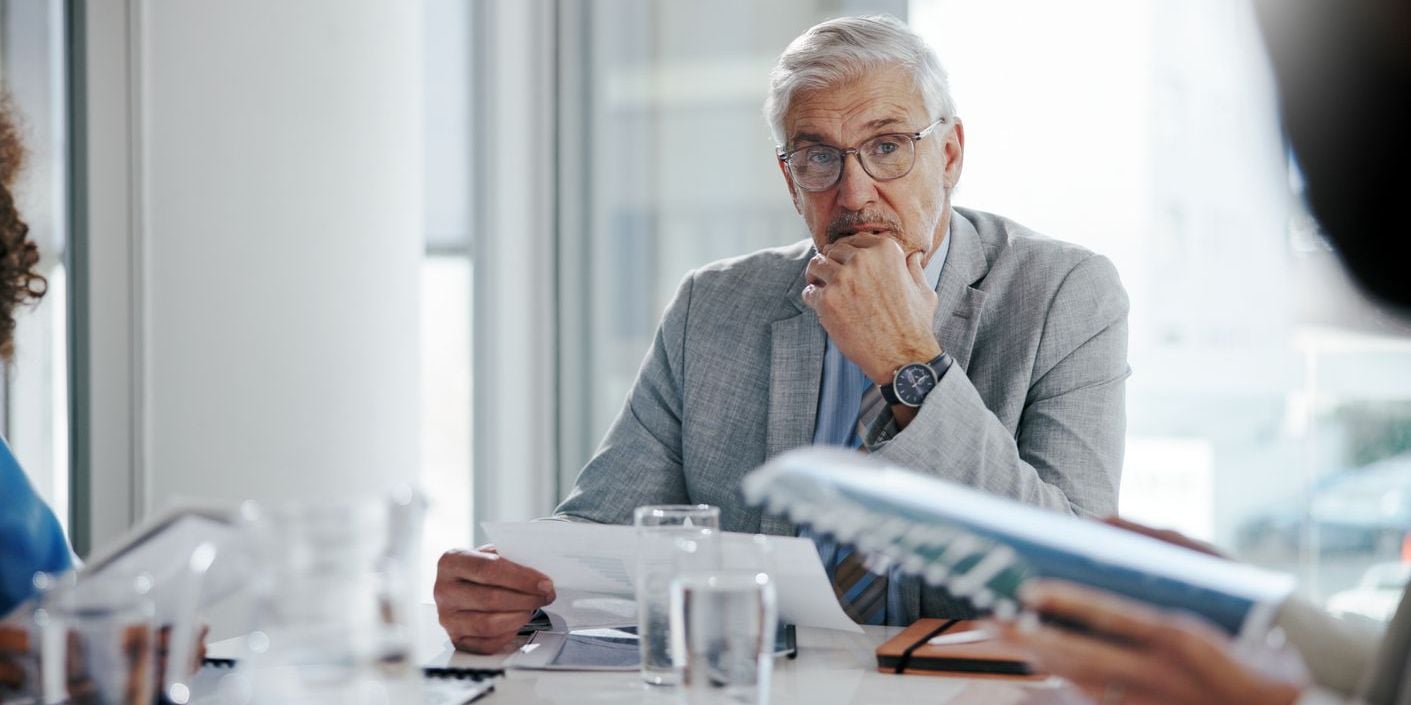 Executive in a meeting reviewing documents